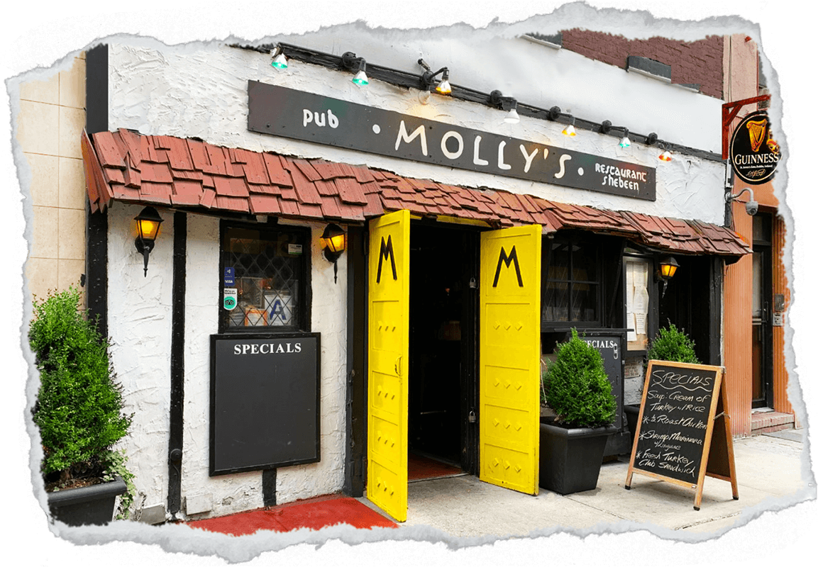 Exterior of Molly's pub and restaurant with bright yellow doors, wooden shingles, and specials menu boards outside.